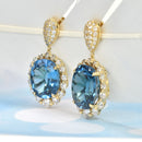Oval Blue Topaz with Diamond Halo Earrings